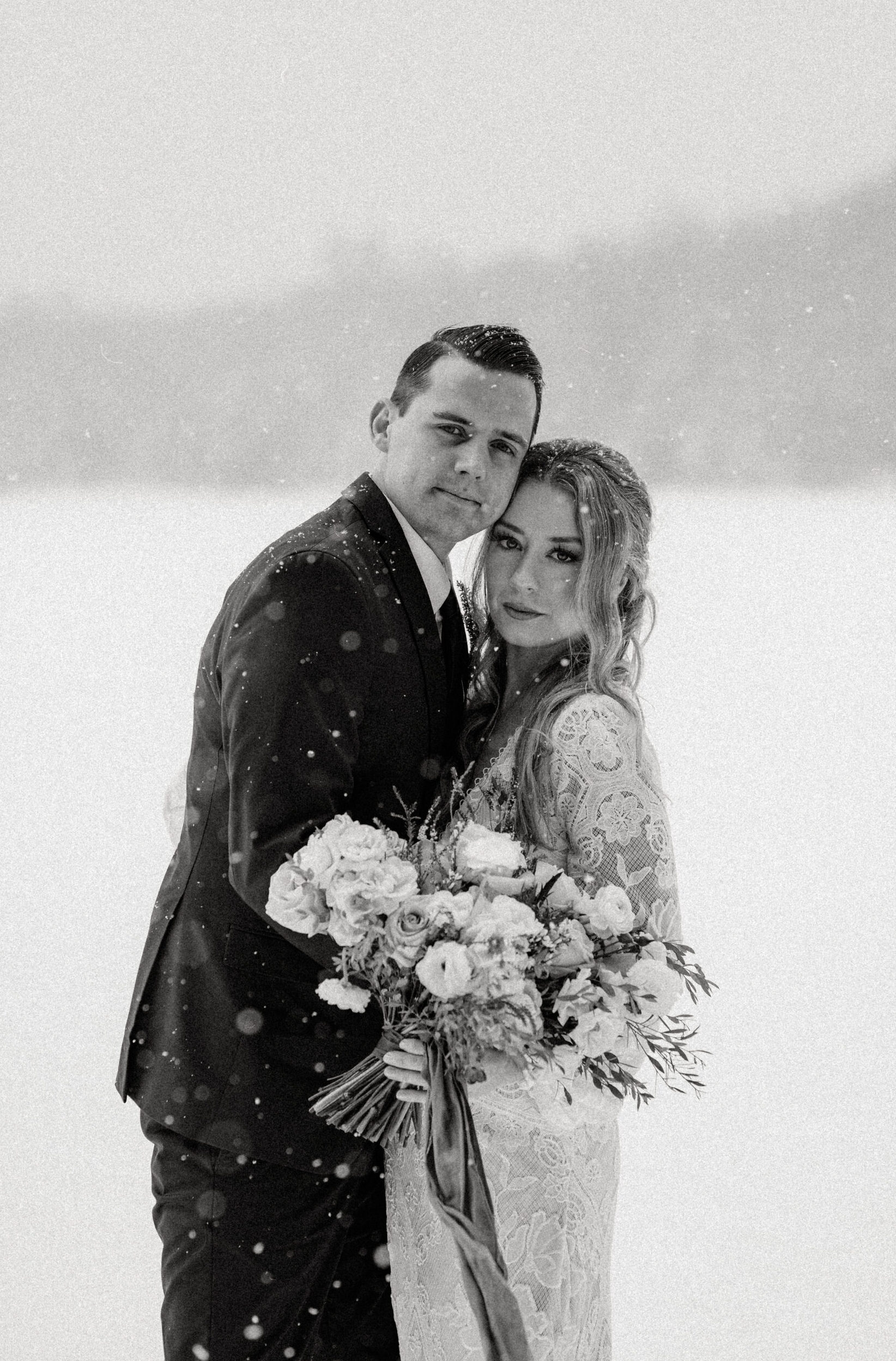 black and white photo of luxury elopement couple in the snow in lake placid new york