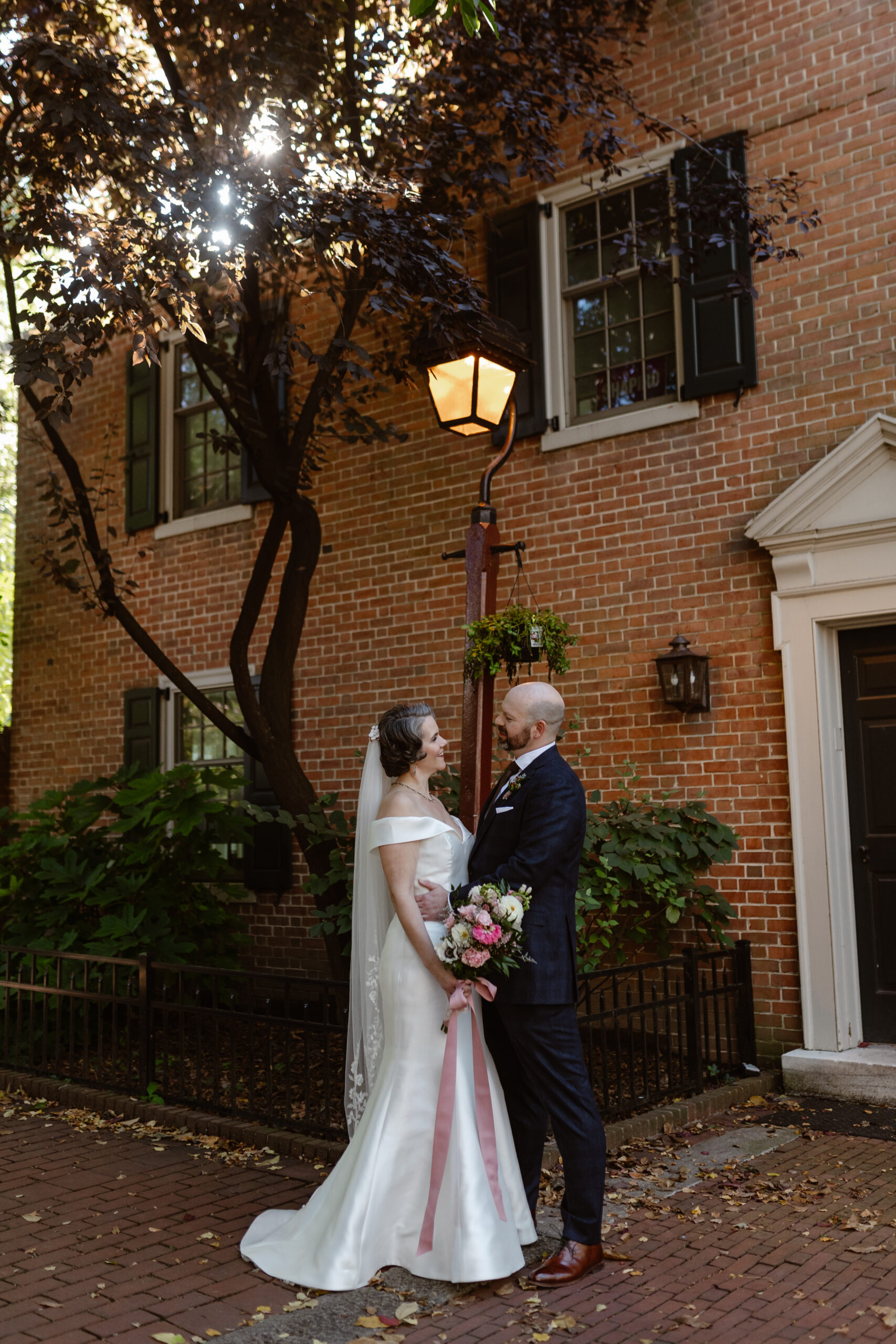 bride and groom with brick house background in society hill for their philadelphia wedding
